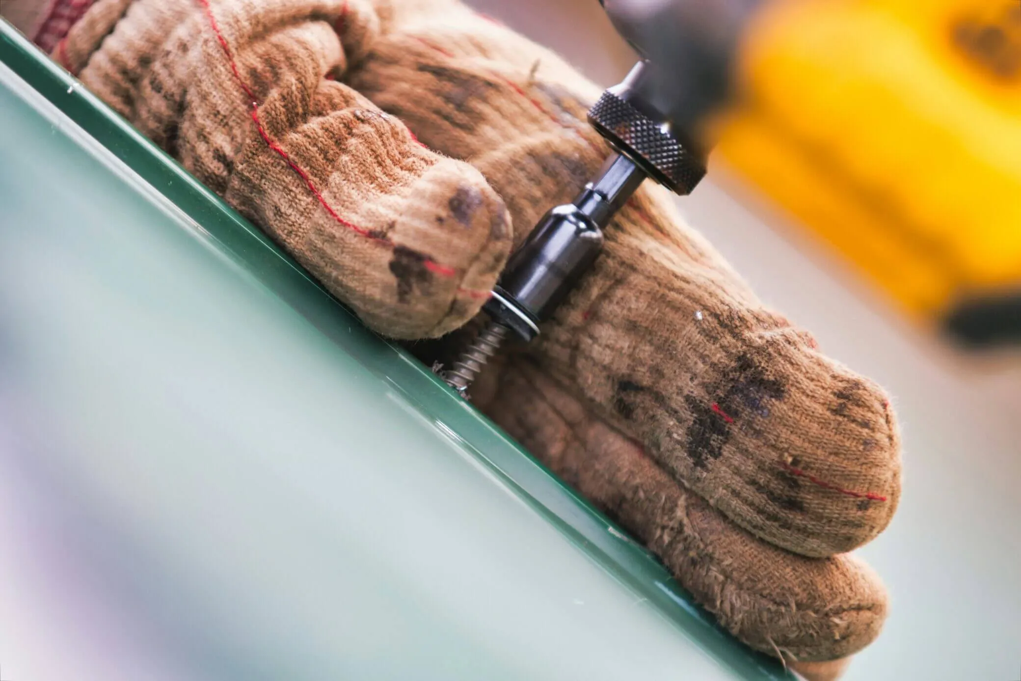 Close-up of a roofer fastening roofing material